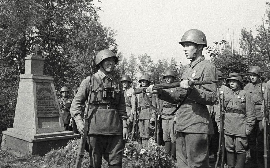 Снайпер С. Номоконов вручает молодому бойцу Б.Канатову винтовку погибшего снайпера.