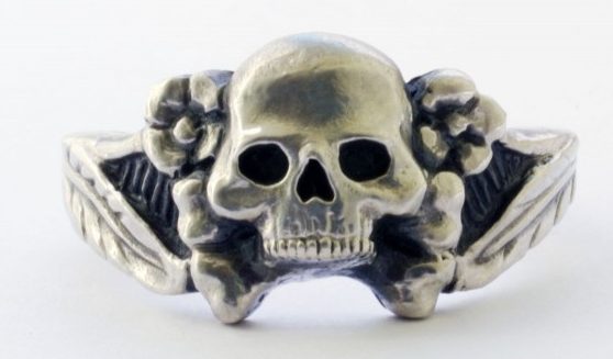 Перстень из серебра 835-ой пробы с применением чернения. В дизайне щитка использованы элементы мертвой головы и цветков эдельвейса. 