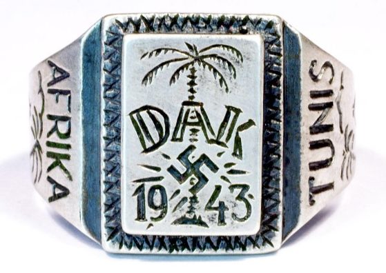 Памятный перстень «Немецкий Африканский Корпус 1943» изготовленный из серебра 835-ой пробы. На щитке изображена эмблема корпуса – свастика на фоне пальмы. По обеих боках щитка надписи «Afrika» и «Tunis».