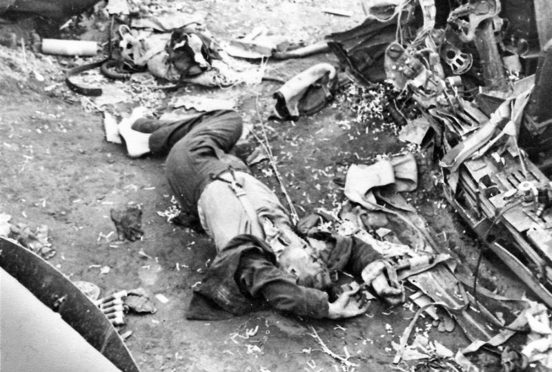 Немецкий летчик у сбитого немецкого бомбардировщика. 1942 г.