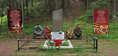 п. Ильичево. Памятник в лесном массиве, установлен на братской могиле, в которой похоронены советские воины, погибшие в годы войны. 