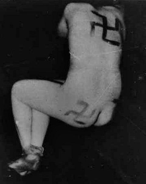 «Маки» разрисовали тело женщины свастиками за сожительство с немцами. Август 1944 г. 