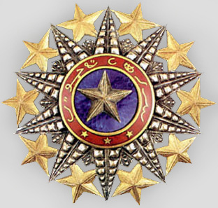 Золотая звезда к знаку Кавалера Большого креста ордена Нишан-эль-Ануара.