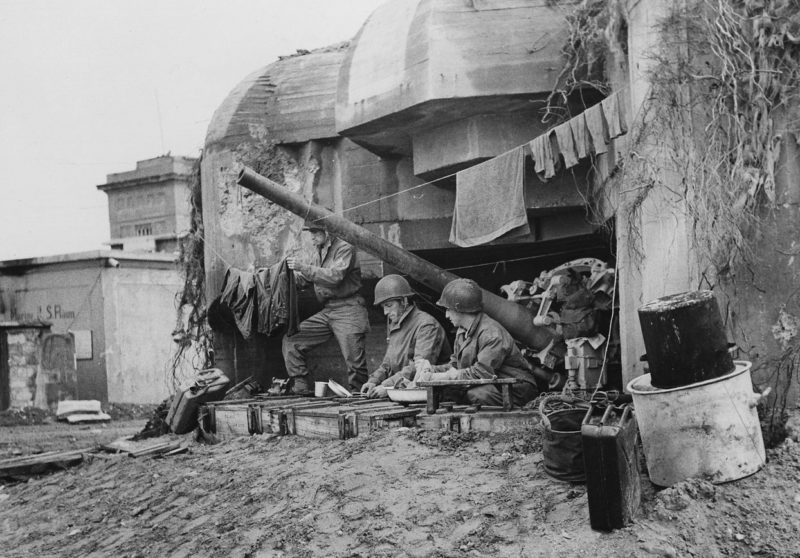 Szövetséges katonák mosogatnak egy elfogott elemen.  Normandia. 1944