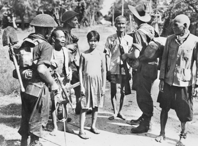 Австралийские солдаты с местными жителями на острове Лабуан. 16 июня 1945 г.