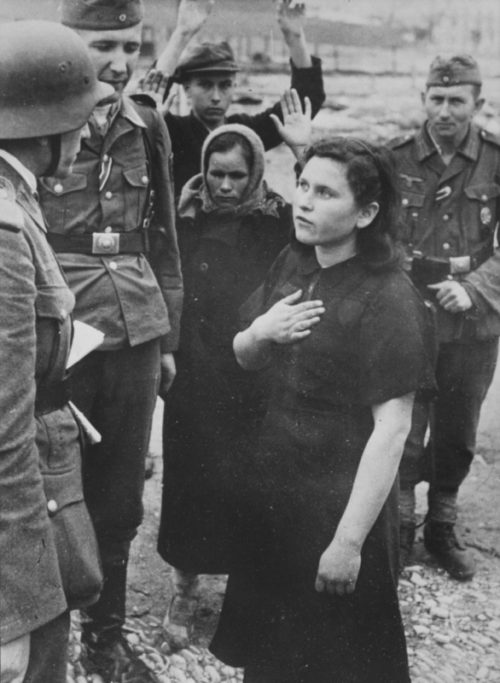 Немецкие солдаты допрашивают задержанных советских граждан на окраине Новороссийска. 1942 г.