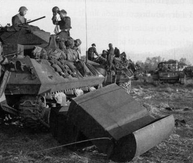 Канадские танкисты снимают гидроизоляцию со своих танков после высадки. 6 июня 1944 г.