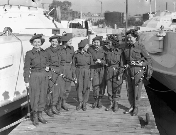 Члены духового оркестра CWAС у трофейных немецких катеров. Вильгельмсхафен, 4 октября 1945 г.