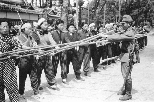 Солдат обучает японских женщин защите бамбуковыми копьями. 1945 г.