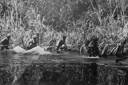 Японские солдаты идут по руслу реки в джунглях Малайи. Февраль 1942 г.