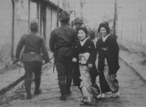 «Женщины для комфорта» из Японии и японские военнослужащие на улице оккупированного населенного пункта в северном Китае. Март 1939 г.