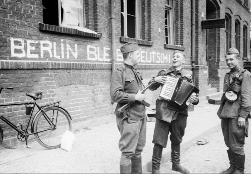 Советские солдаты с гармонью на одной из улиц Берлина.