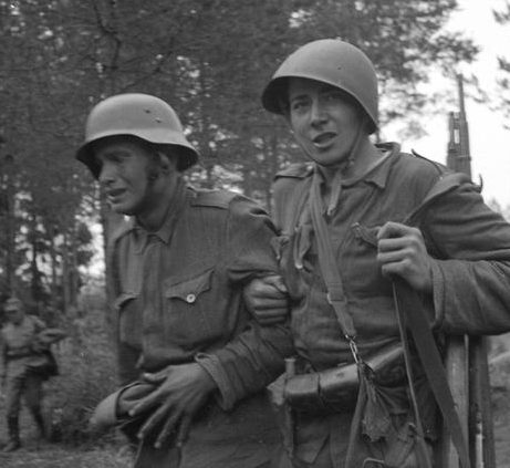 Финский солдат провожает контуженого товарища на станцию помощи. Вуосалми, 13 июля 1944 г.