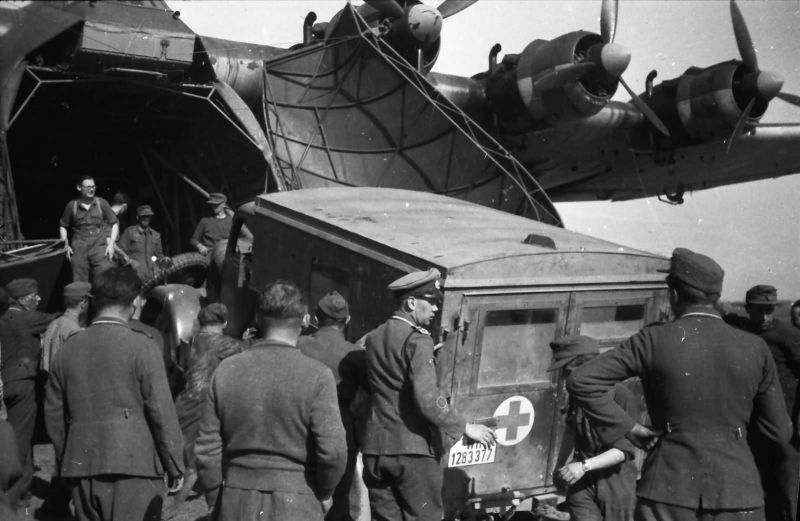 Немецкие солдаты помогают заехать санитарному автомобилю в транспортный самолет. 1941 г. 