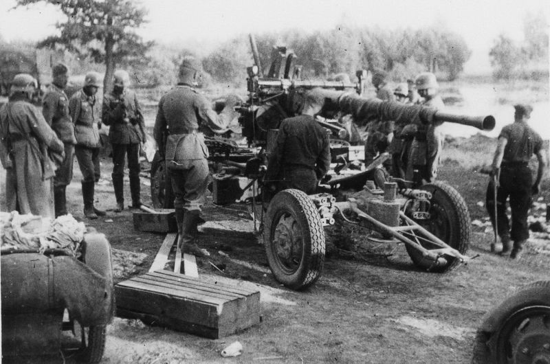 Немецкие солдаты рассматривают британскую 40-мм автоматическую зенитную пушку Bofors L60, брошенную при эвакуации из Франции. Май 1940 г. 