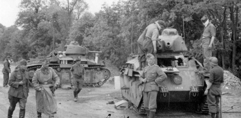 Пленные французские танкисты вытаскивают из подбитых танков Char D2 своих погибших товарищей. 1940 г. 