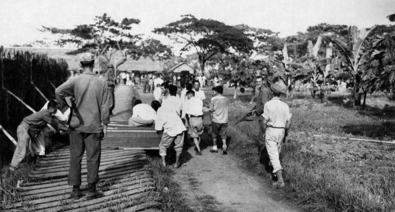 Японские военнопленные под конвоем несут гробы в Маниле. Февраль 1942 г. 