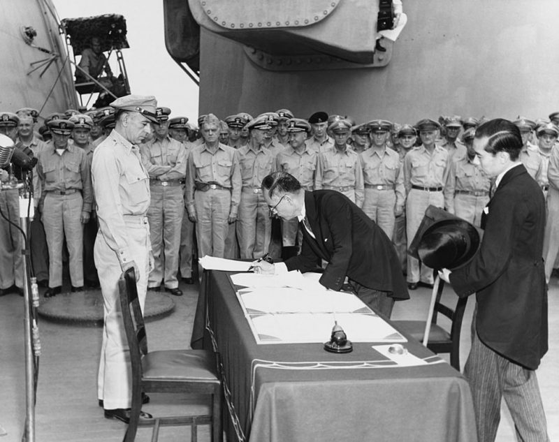 Сигэмицу подписывает акт о капитуляции Японии в сопровождении Тошикадзу Касэ. 2 сентября 1945 г.