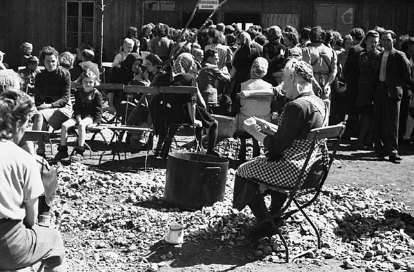 Беженцы в лагере Дахау перед раздачей еды. 1946 г.