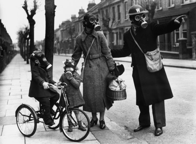 Служащий гражданской обороны дает указания женщине с детьми в Лондоне. 1941 г.