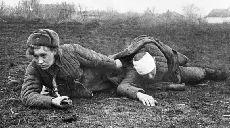 Санинструктор эвакуирует раненого с поля боя на Украине. Февраль 1944 г. 