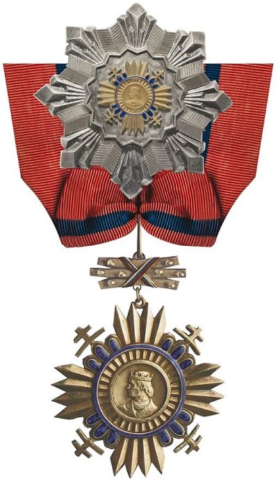 Звезда и знак Великого офицера Ордена князя Прибины на шейной ленте.