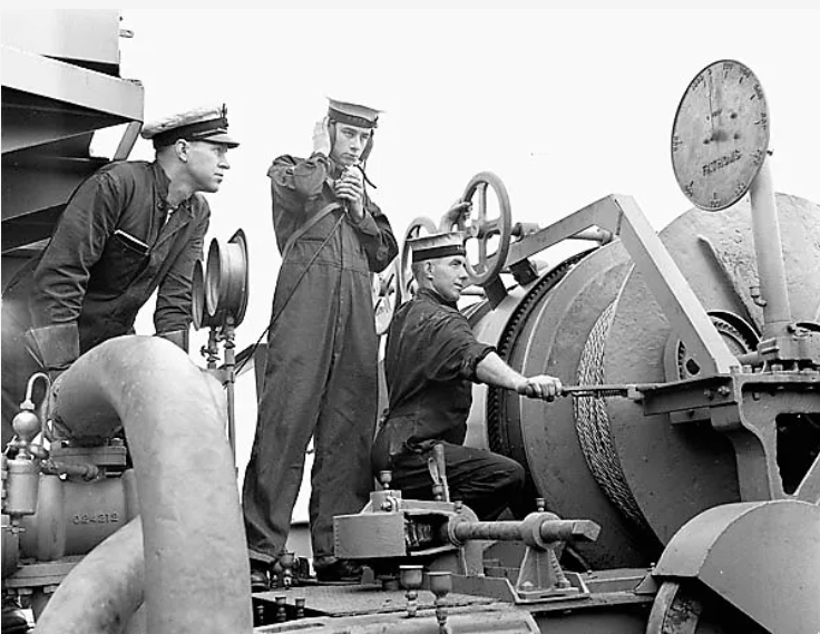 Матросы HMCS Alberni разматывают кабель во время учений по тралению мин. 1941 г.